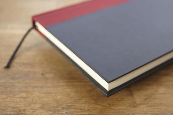Diary with 160 blank pages, black hard cover, wine-red linen spine, headband